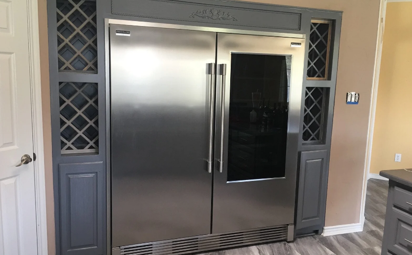 Custom built-in refrigerator with lattice wine storage cabinetry